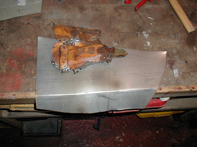 Trying to figure out what the shape the original panel was from the remove section. The separate bracket spot welded to the panel is the mount for the luggage strap.