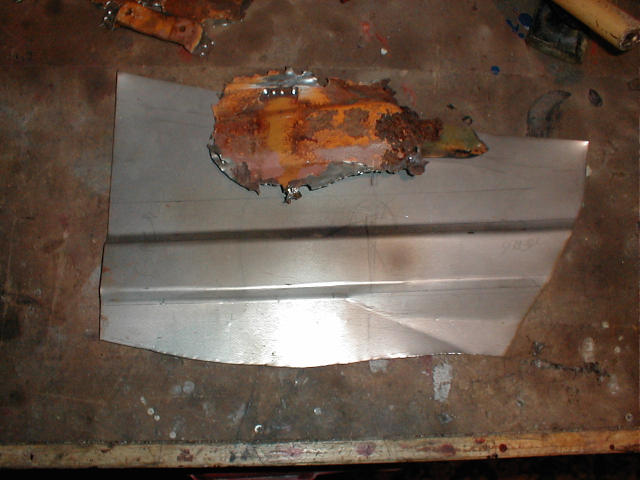 Starting to form the shape of the original pressings as best I could. I removed the luggage strap bracket to replace on the new panel.