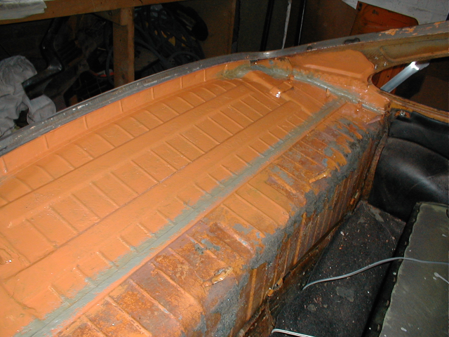 A coat of smooth Hammerite (mixed red and yellow to get a reasonable match to the Signal Orange.) Its all hidden under the thick foam sound deadening anyway